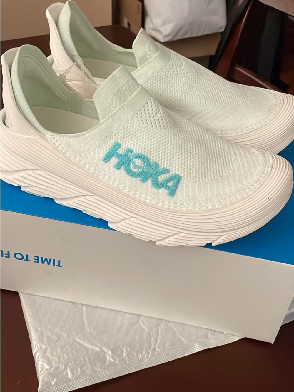 The Hoka Restore TC slip-on in the Frost/Cloudless color Men 12 Women 13
